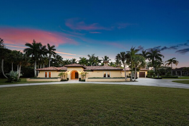 mediterranean / spanish-style house featuring a lawn