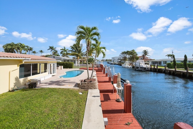 dock area with a yard, a water view, and a patio area