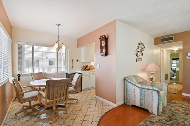 dining area featuring a chandelier and light hardwood / wood-style floors