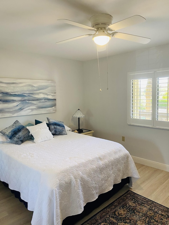 bedroom featuring ceiling fan and wood-type flooring