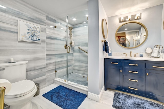 bathroom featuring vanity, toilet, and a shower with shower door