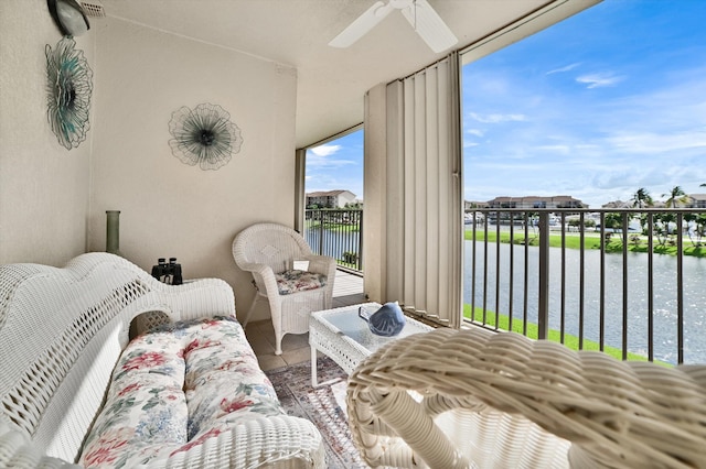 bedroom featuring a water view and ceiling fan