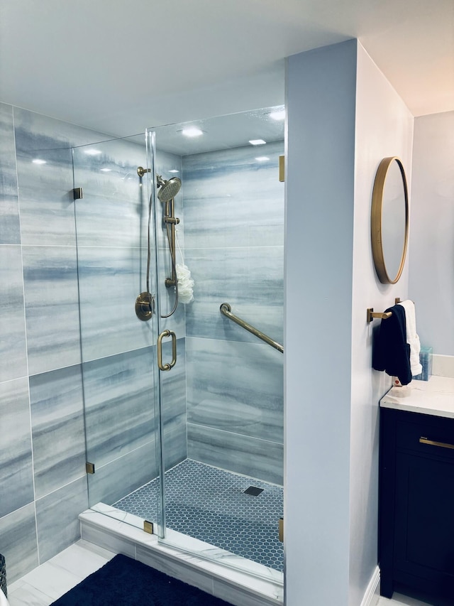 bathroom featuring tile patterned floors, vanity, and walk in shower