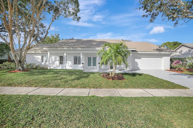 ranch-style home with french doors, a garage, and a front lawn