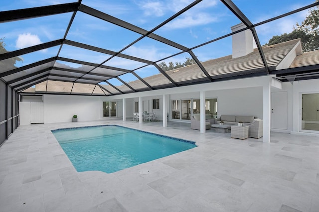 view of swimming pool with outdoor lounge area, glass enclosure, and a patio