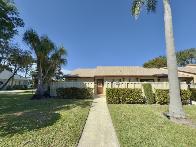 ranch-style home with a front yard