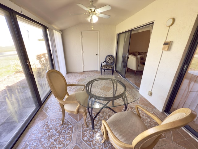 sunroom with ceiling fan and lofted ceiling