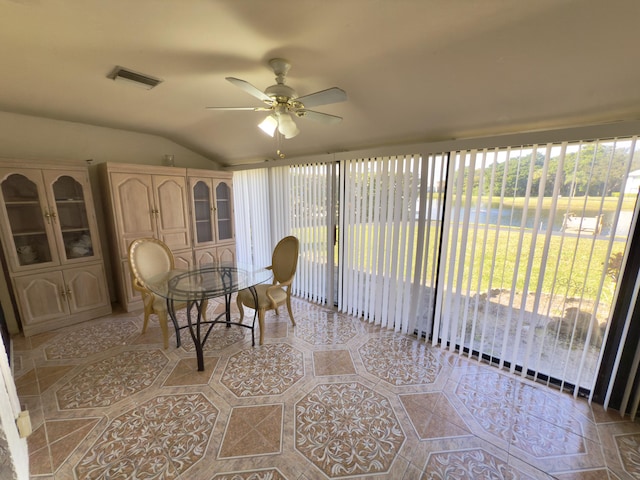 sunroom / solarium with ceiling fan and vaulted ceiling