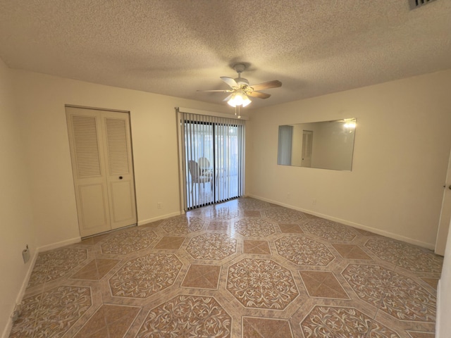 spare room featuring ceiling fan and a textured ceiling