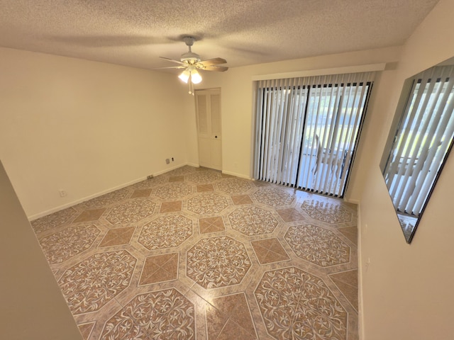 empty room featuring ceiling fan and a textured ceiling