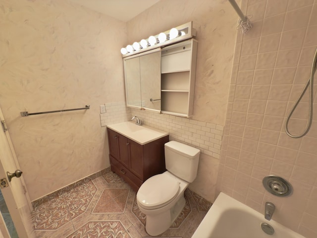 full bathroom with tiled shower / bath combo, toilet, and vanity