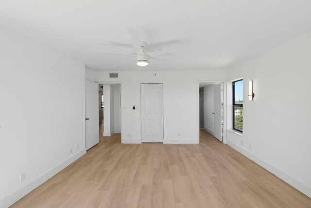 unfurnished bedroom with ceiling fan, light hardwood / wood-style floors, and a closet