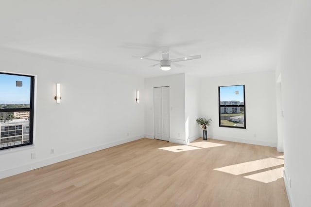 spare room with light hardwood / wood-style flooring and ceiling fan