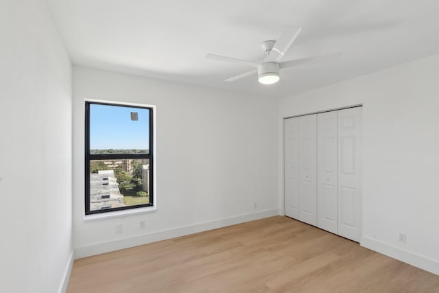 unfurnished bedroom with a closet, ceiling fan, and light hardwood / wood-style flooring