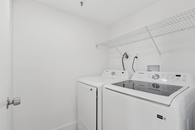 washroom featuring washer and clothes dryer