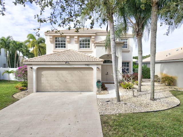 mediterranean / spanish home with a garage