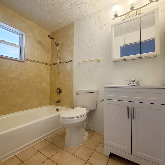 full bathroom with a textured ceiling, tile patterned flooring, tiled shower / bath combo, and toilet