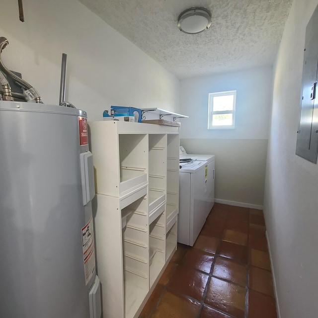 clothes washing area with a textured ceiling, electric water heater, and washing machine and dryer