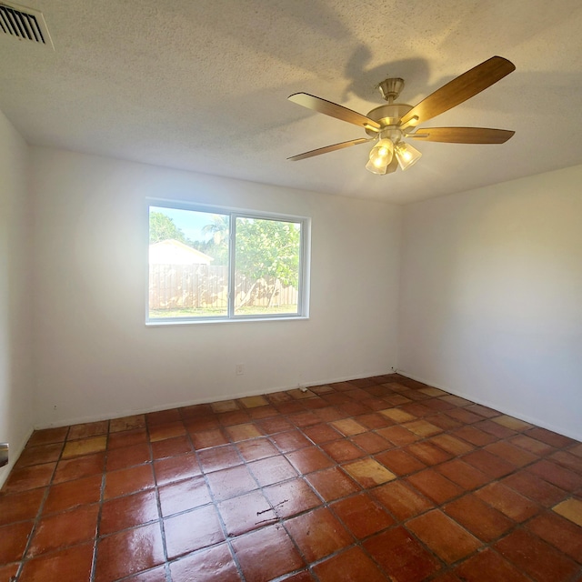 spare room featuring a textured ceiling and ceiling fan