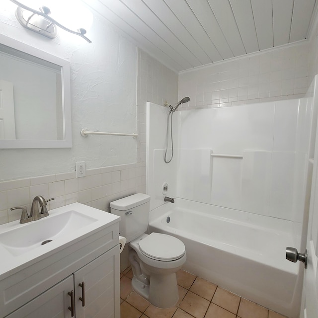 full bathroom with tile patterned flooring, toilet, vanity, tile walls, and  shower combination