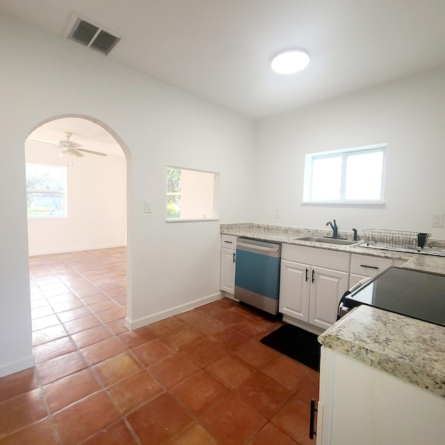 kitchen with sink, white cabinetry, tile patterned flooring, ceiling fan, and stainless steel dishwasher