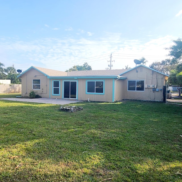 back of house featuring a patio and a lawn