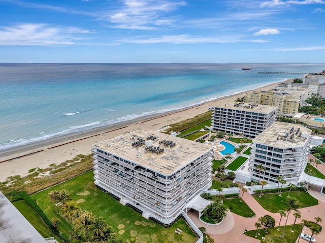 birds eye view of property with a water view and a beach view