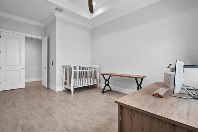 bedroom with a crib and crown molding