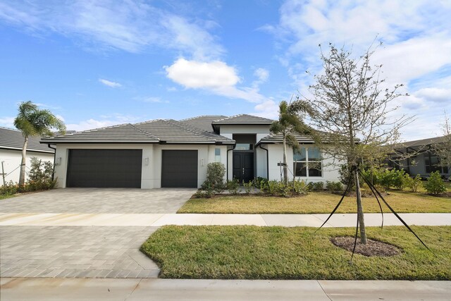 view of front facade with a front yard and a garage