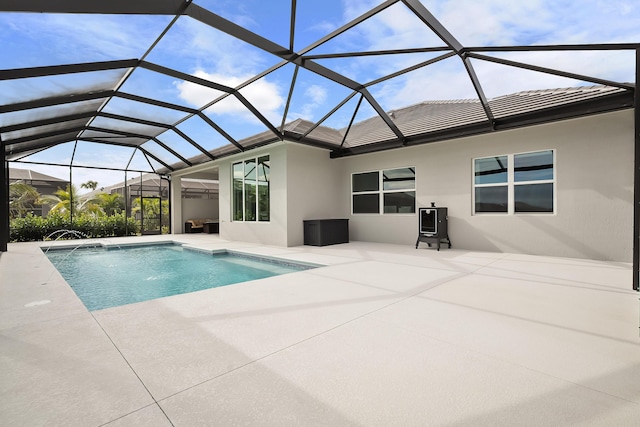 outdoor pool with a lanai and a patio area