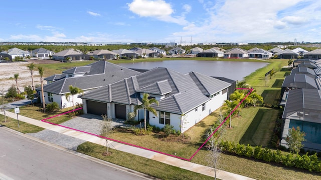 birds eye view of property featuring a residential view and a water view