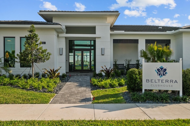 property entrance with french doors and stucco siding