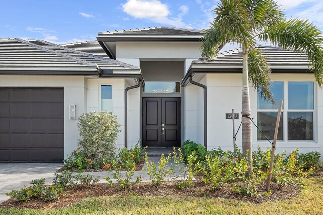 doorway to property with a garage