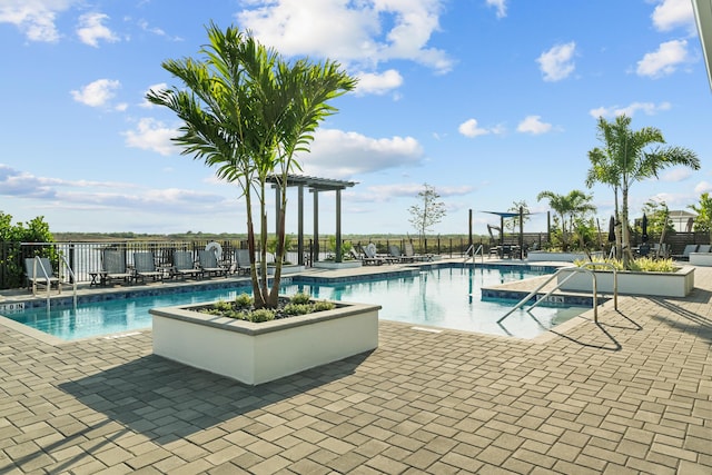 community pool featuring a patio and fence