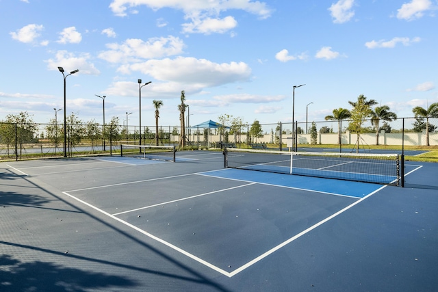 view of sport court featuring fence