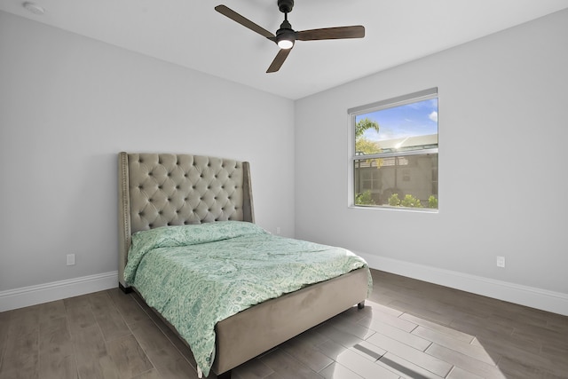 bedroom featuring wood finished floors, a ceiling fan, and baseboards