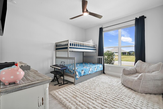 bedroom with light hardwood / wood-style flooring and ceiling fan