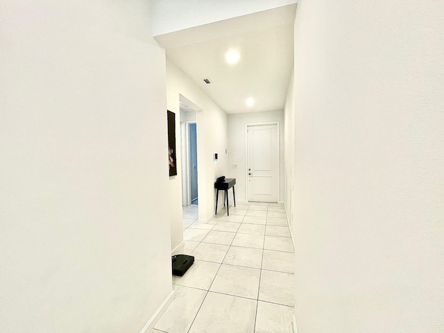 corridor with light tile patterned floors