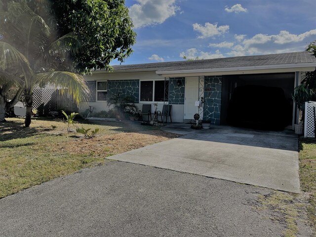 ranch-style home with a front yard and a carport