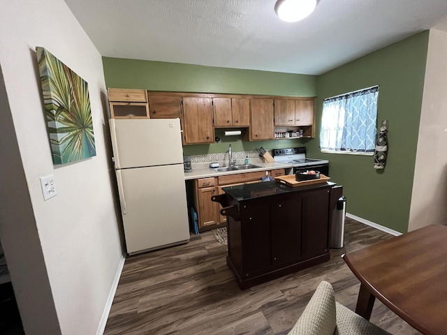 kitchen featuring white refrigerator, range with electric cooktop, sink, and dark hardwood / wood-style flooring