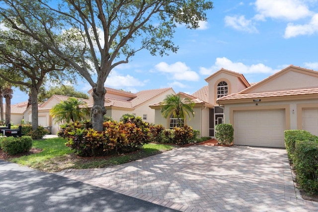 mediterranean / spanish-style house with a garage