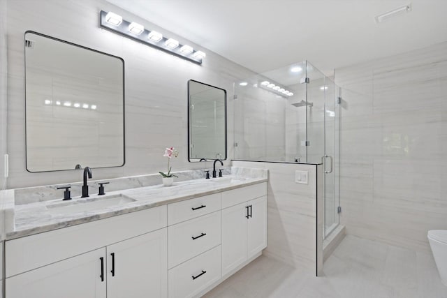 bathroom featuring vanity, toilet, and a shower with door