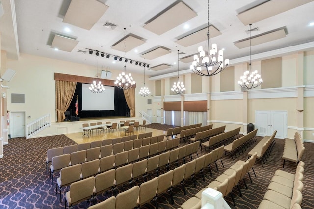 cinema room with a towering ceiling, coffered ceiling, and dark colored carpet