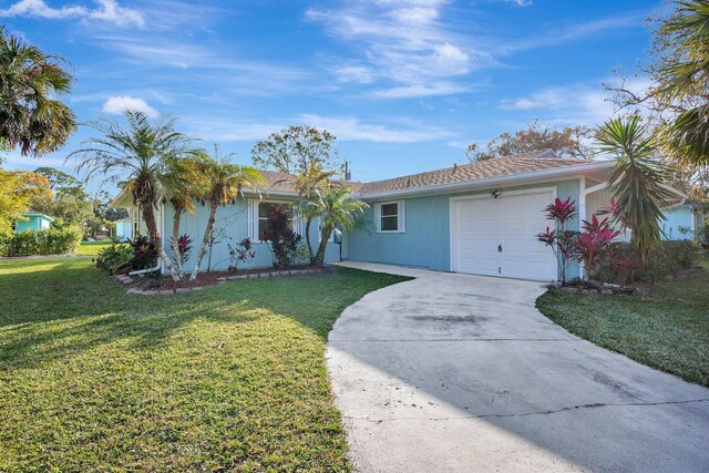 single story home with a front yard and a garage