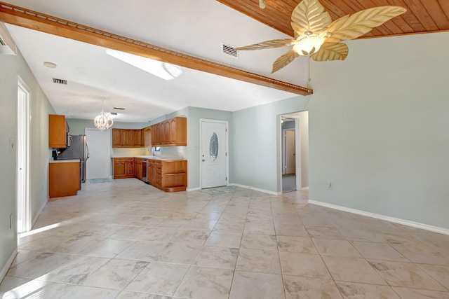 unfurnished living room with ceiling fan with notable chandelier