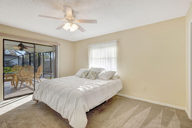 carpeted bedroom with ceiling fan, access to outside, and a textured ceiling