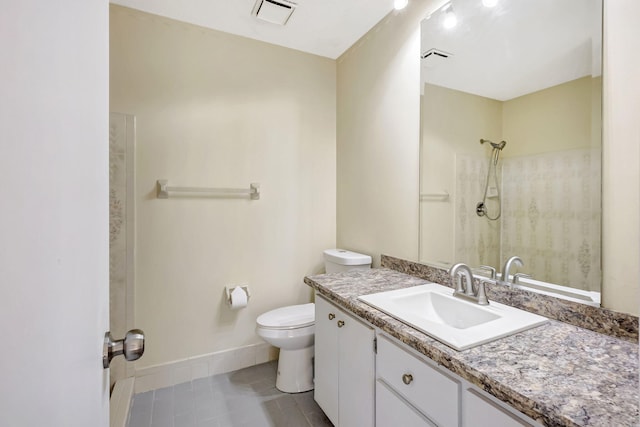 bathroom with vanity, a shower, tile patterned floors, and toilet