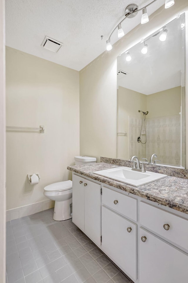 bathroom with vanity, walk in shower, toilet, tile patterned floors, and a textured ceiling