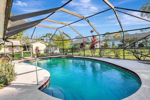 view of pool featuring a patio and glass enclosure