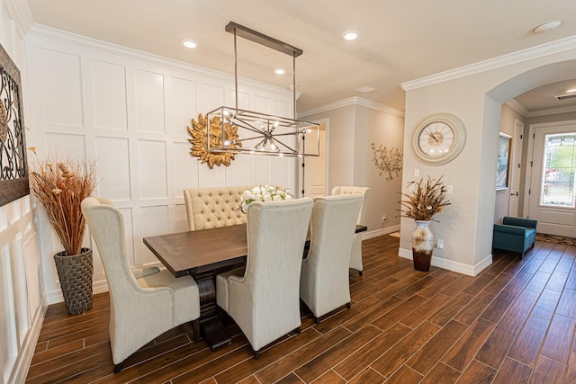 dining area with a notable chandelier and crown molding